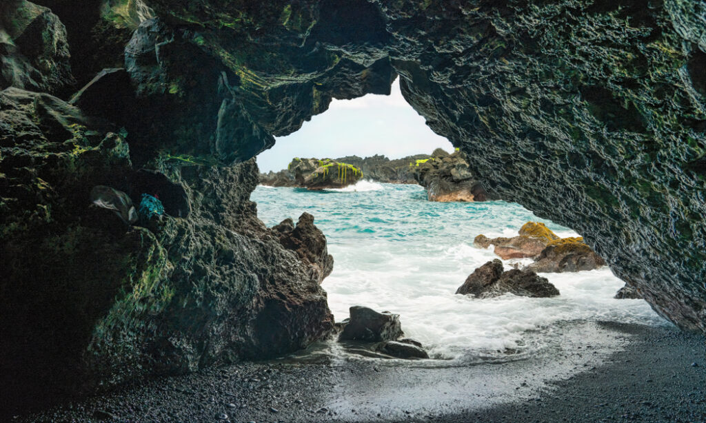 Inside a Hawaiian Lava Tube – Ocean View Through Volcanic Rock