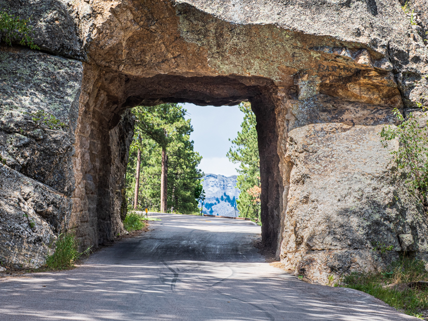 Close-up view through Shovel Johnson Tunnel perfectly framing Mount Rushmore in the distance, Custer State Park, South Dakota