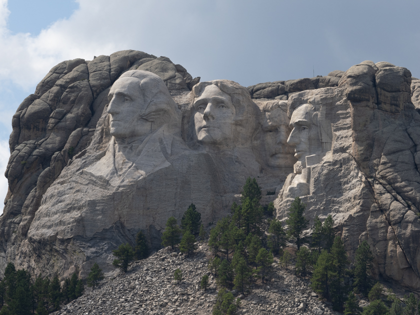 Distant view of Mount Rushmore carved into the Black Hills as seen from a scenic lookout in Custer State Park, South Dakota