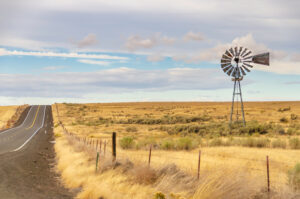 Old windmill in field with fence