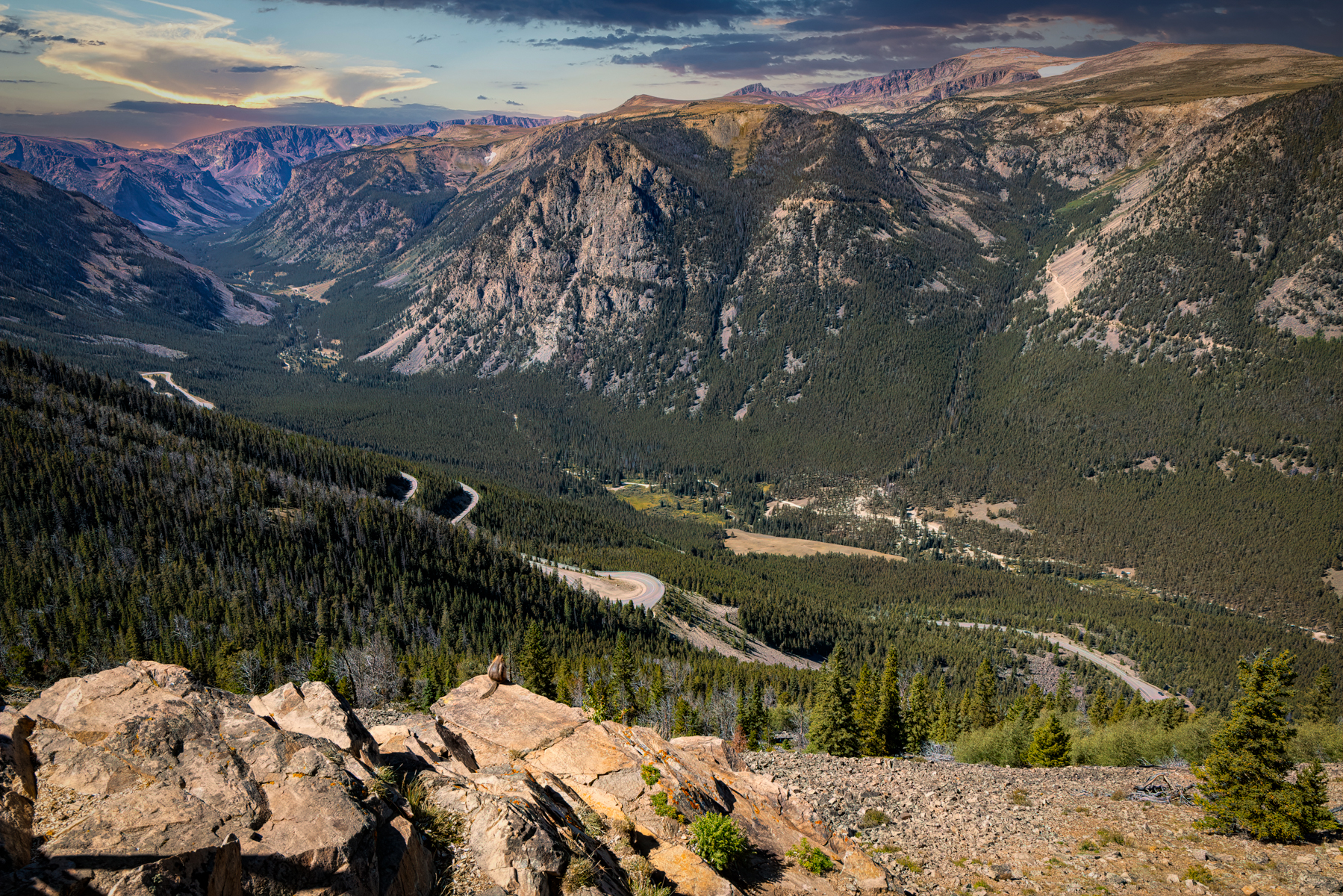 Aerial view of the Beartooth Highway winding through snow-dusted mountains and alpine landscape
