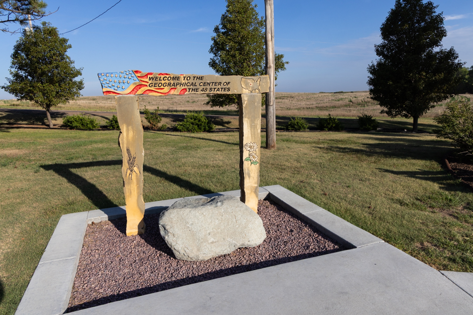 Welcome sign at the Geographic Center of the Continental United States in Lebanon, Kansas, set against open prairie Kansas travel blog, scenic drives in Kansas, Midwest road trip, Kansas landscapes, Kansas travel photography
