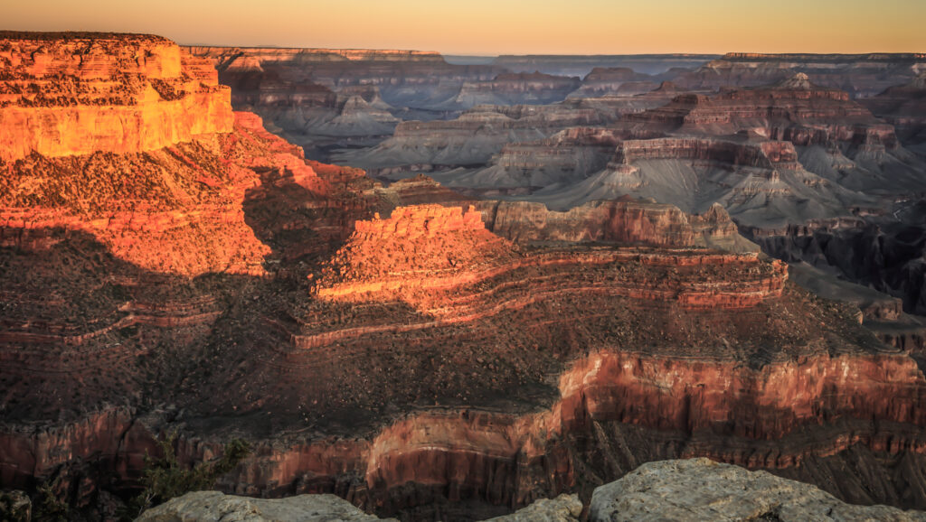 The Grand Canyon at sunset with vibrant skies and dramatic rock formations.  Southwest Region travel guide