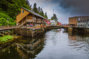 Colorful historic buildings of Married Man’s Row in Ketchikan, Alaska, reflected in the calm waterfront.