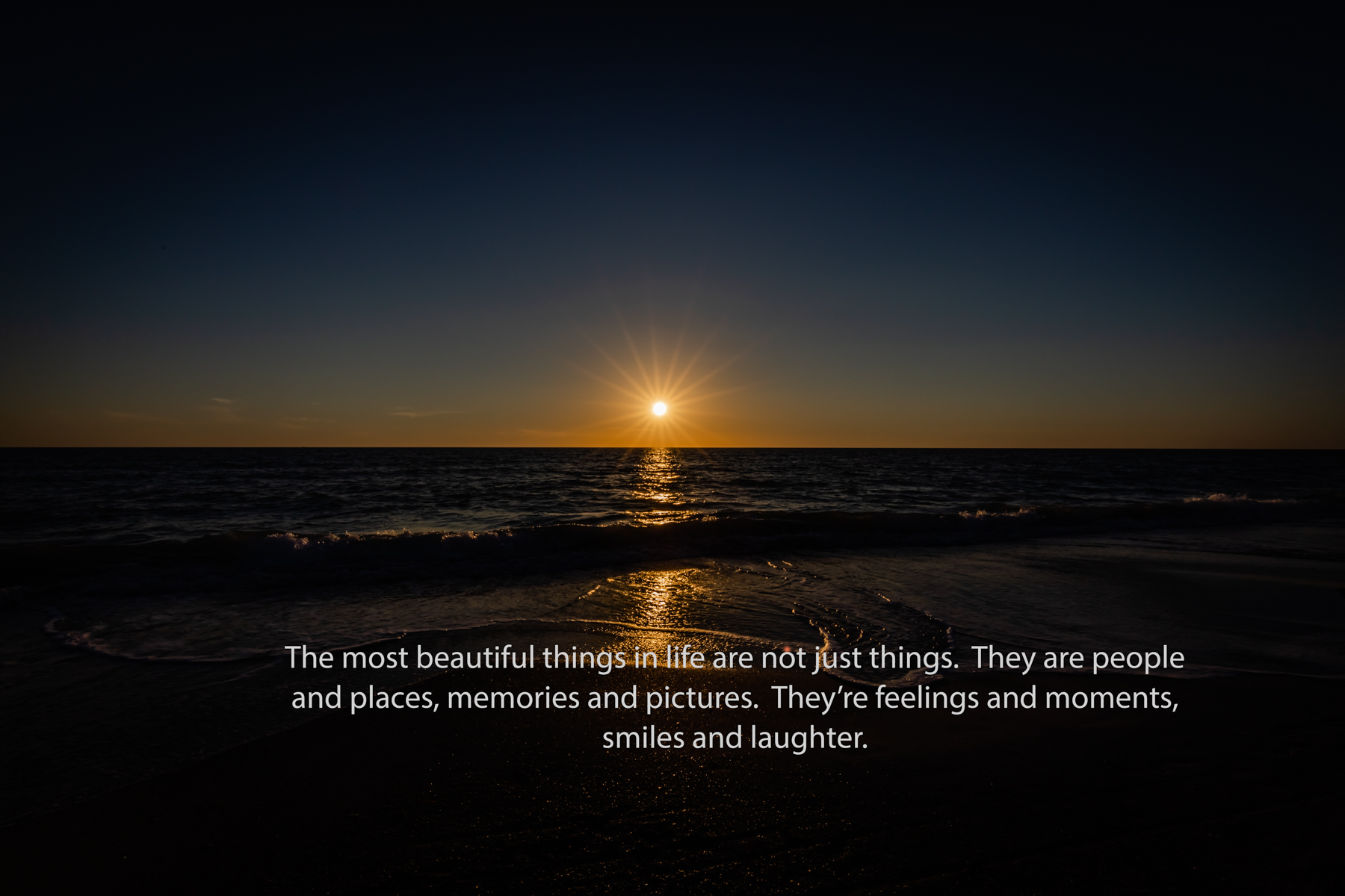 Ocean sunset with warm light on the beach and an inspirational quote about life, memories, and moments.