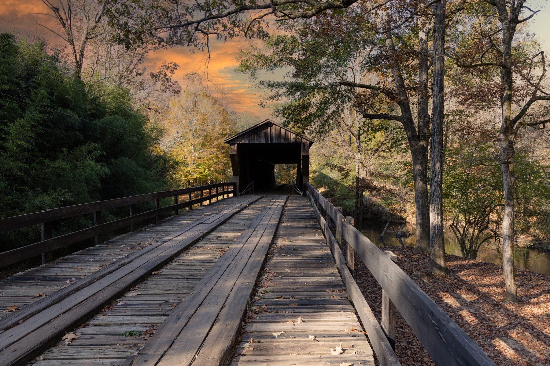 Red Oak Creek Covered Bridge in Georgia framed by glowing sunset skies.