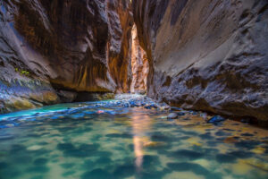 view of canyon with a turquoise river flowing through it.