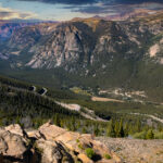 Scenic view of the Beartooth Highway winding through mountainous terrain with dramatic skies and alpine landscapes.