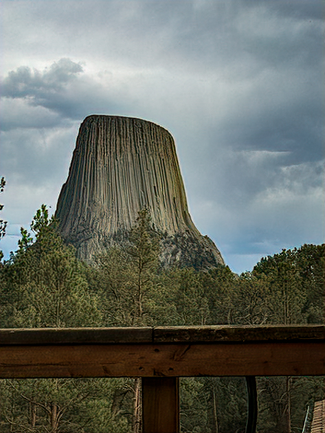 Scenic view of Devil’s Tower rising above the trees, seen from Devil’s Tower Lodge in Wyoming