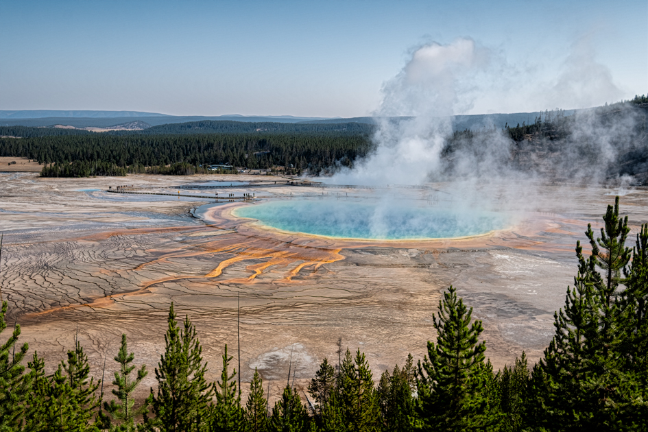 Stunning view of Grand Prismatic Spring from the Fairy Falls Overlook Trail in Yellowstone National Park, showing vibrant thermal colors.