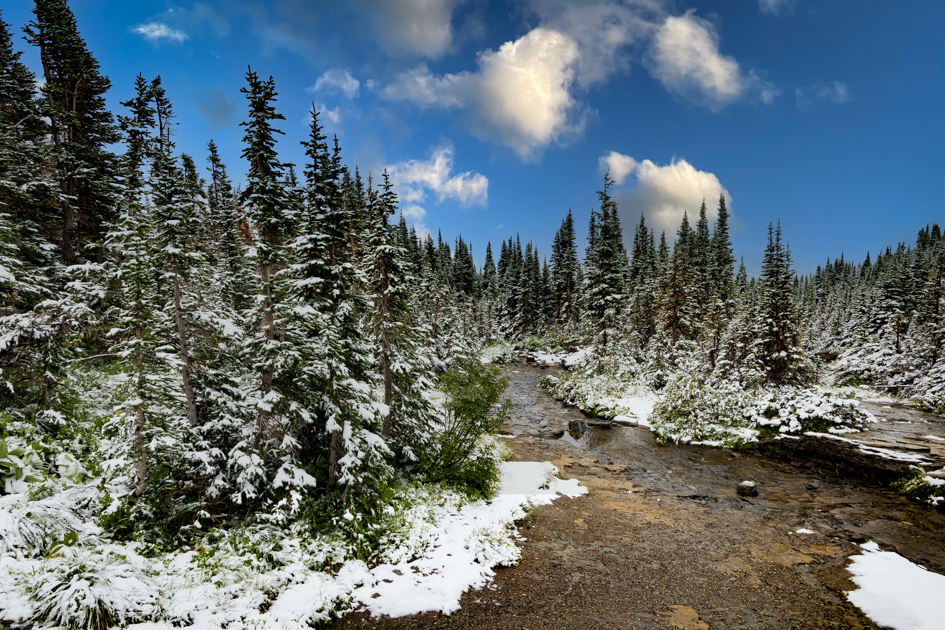 Patches of snow lingering on mountain slopes during summer in Glacier National Park