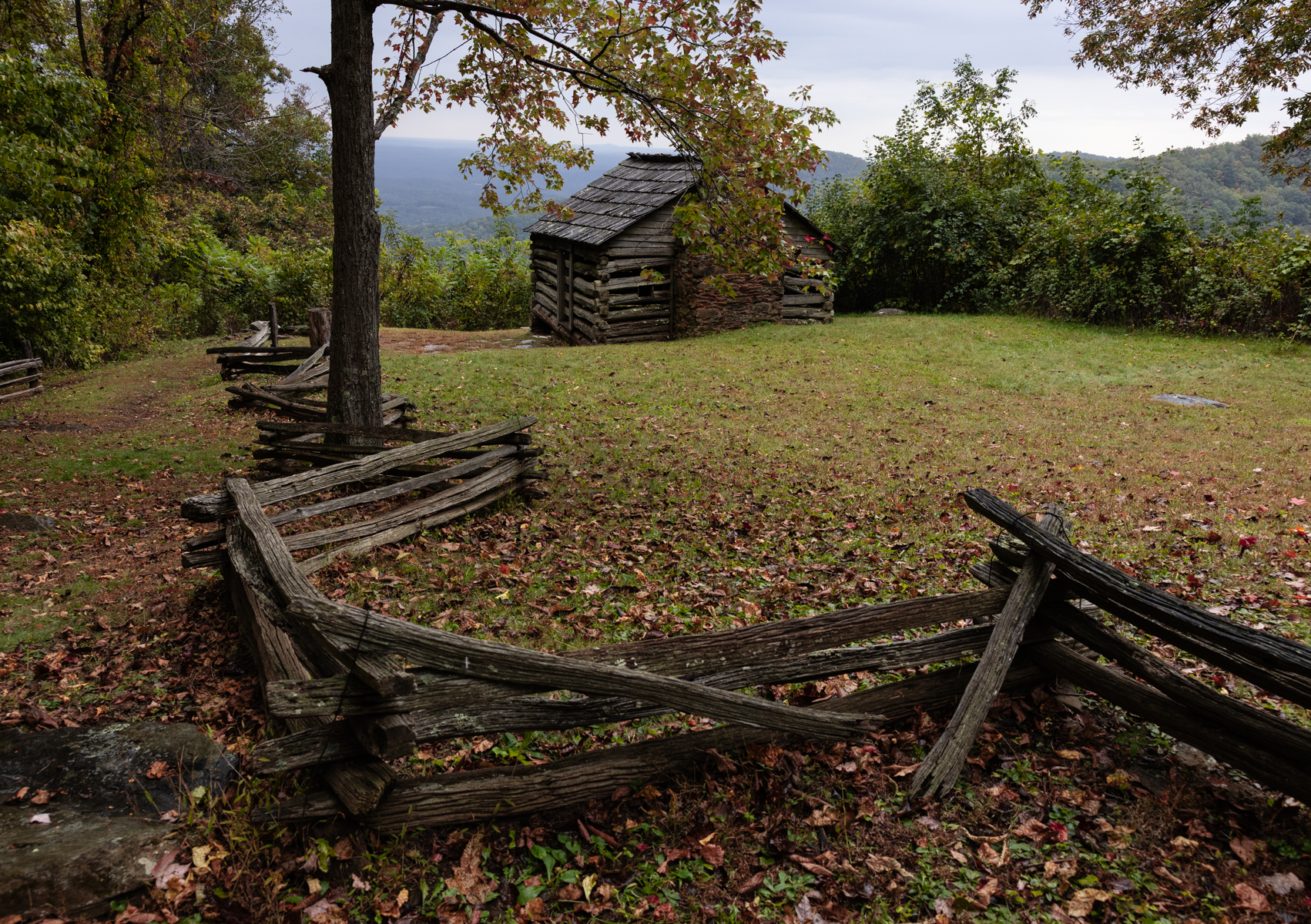cabin in the mountains with a rustic fence