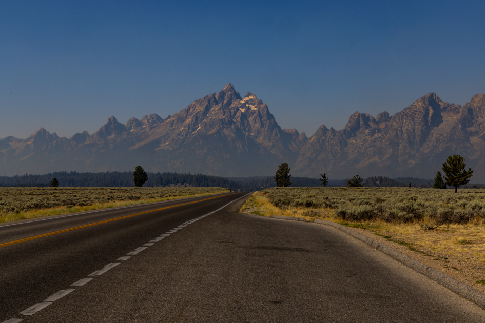 Road leading into Grand Teton National Park with the Teton Range rising in the distance under a dramatic sky, Grand Teton National Park
30-day USA road trip
things to do in Grand Teton
Grand Teton bike trails
Mormon Row Grand Teton
wildlife in Grand Teton
where to stay in Jackson WY
Grand Teton photography spots