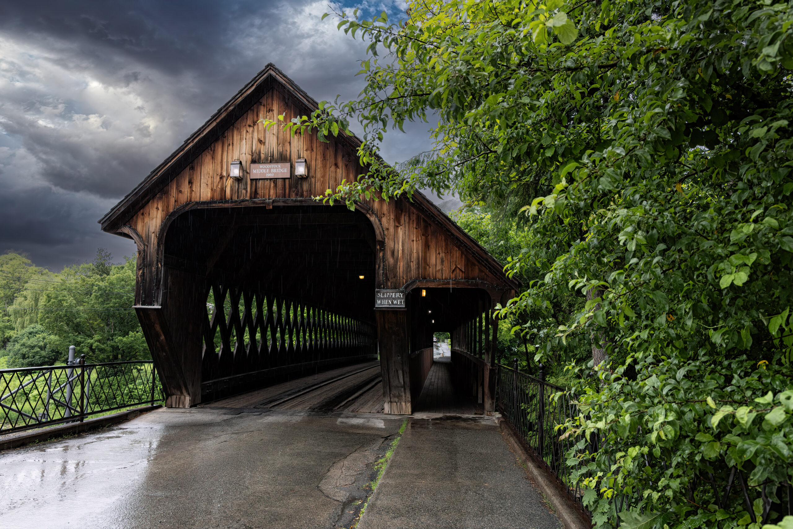 Woodstock Middle Bridge in Vermont under dramatic, stormy skies.