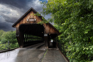 rustic covered bridge with storm clouds