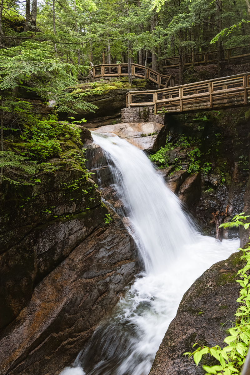 Sabbaday Falls cascading through a rocky gorge surrounded by forest in the White Mountains of New Hampshire.
