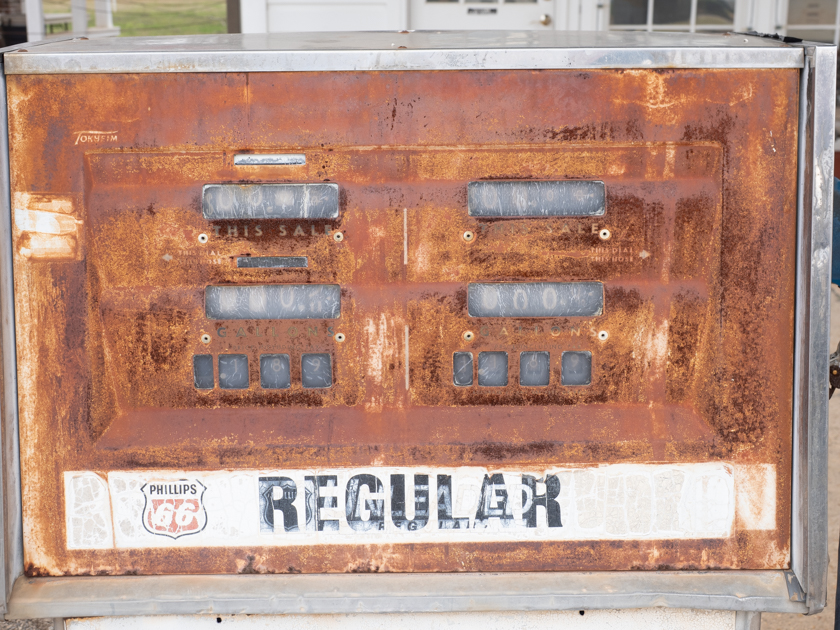 Close-up of vintage gas pumps at Billy Carter’s historic service station in Plains, Georgia, with weathered paint and retro details.
