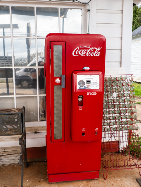 Vintage red Coca-Cola machine at Billy Carter’s gas station in Plains, Georgia, showing signs of age and Southern charm.
