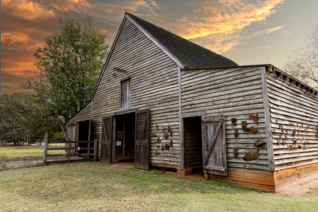 Back view of Jimmy Carter’s childhood barn glowing at sunset in rural Georgia
