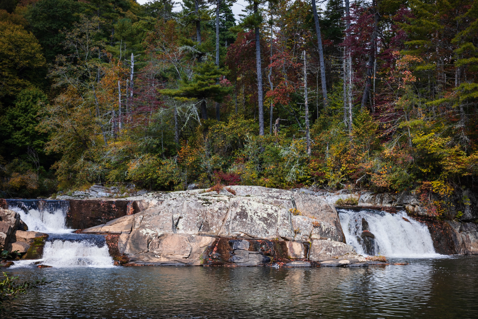 Linville Falls cascading over rugged rock cliffs, surrounded by lush forest at Milepost 317 on the Blue Ridge Parkway.

