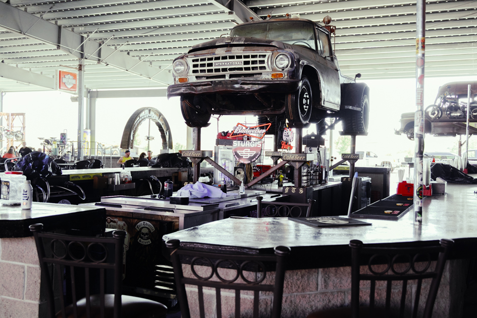 Bar at Full Throttle Saloon with a vintage pickup truck mounted overhead as part of the decor.