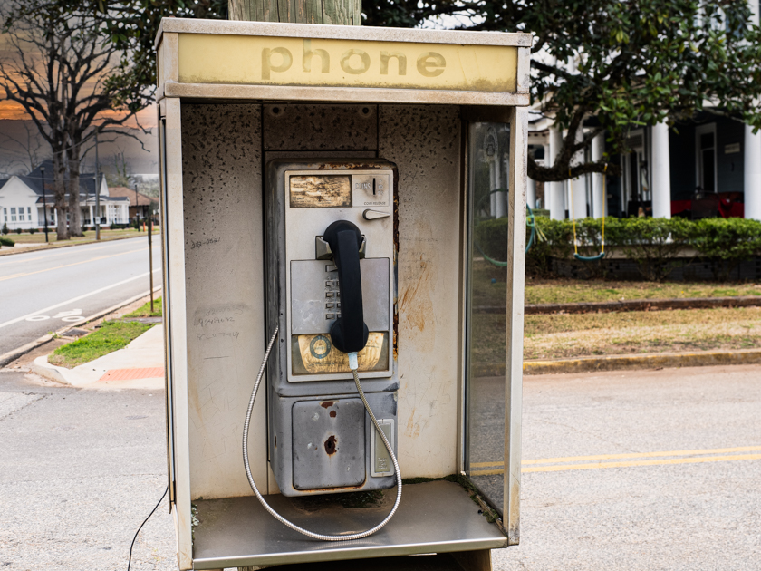 Old pay telephone at  Billy Carter’s gas station in Plains, Georgia, weathered by time.
