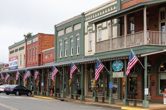 View of the quaint downtown area of Plains, Georgia, featuring historic brick buildings, local shops, and small-town Southern charm.
