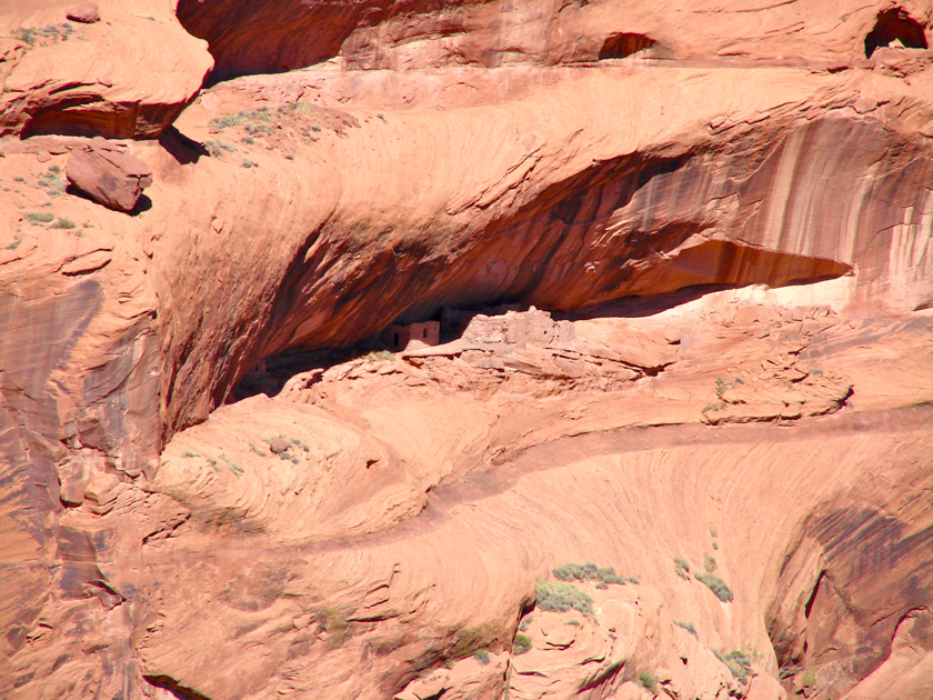 Cliff dwellings built into the red sandstone walls of Canyon de Chelly in Arizona.