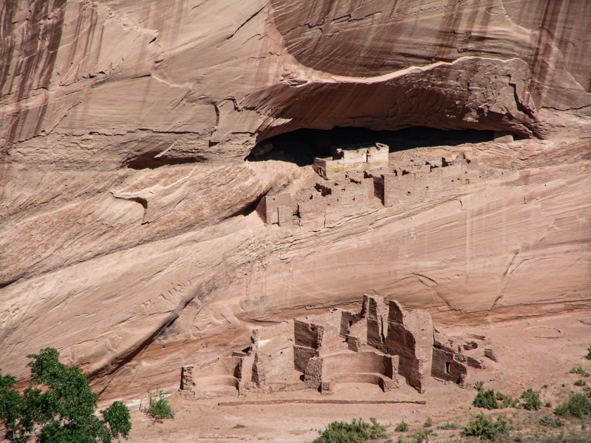 Two levels of Canyon de Chelly in Arizona with red sandstone cliffs and canyon floor visible.