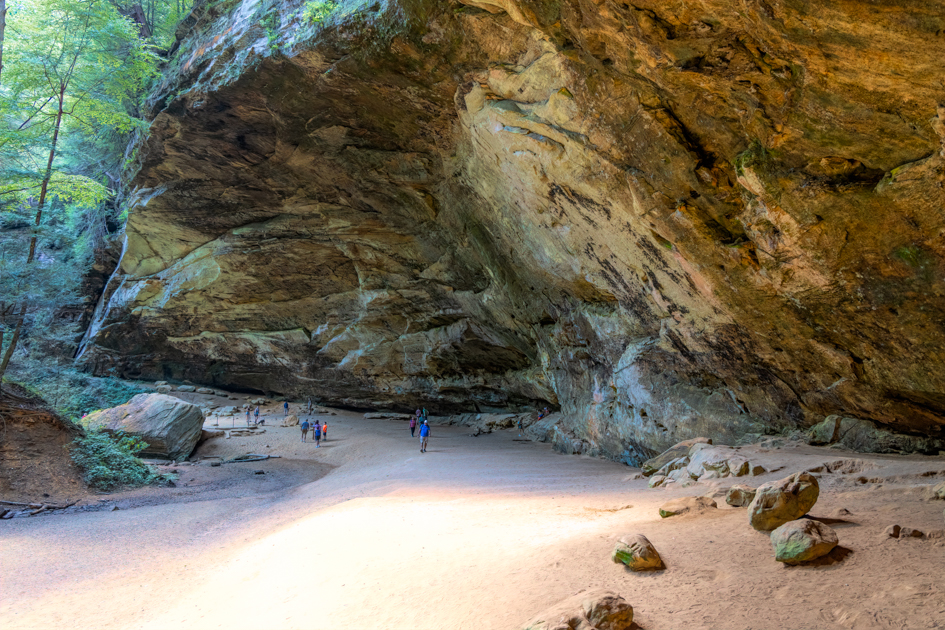 Ash Cave in Hocking Hills, Ohio, with towering sandstone walls and a sweeping natural amphitheater.
