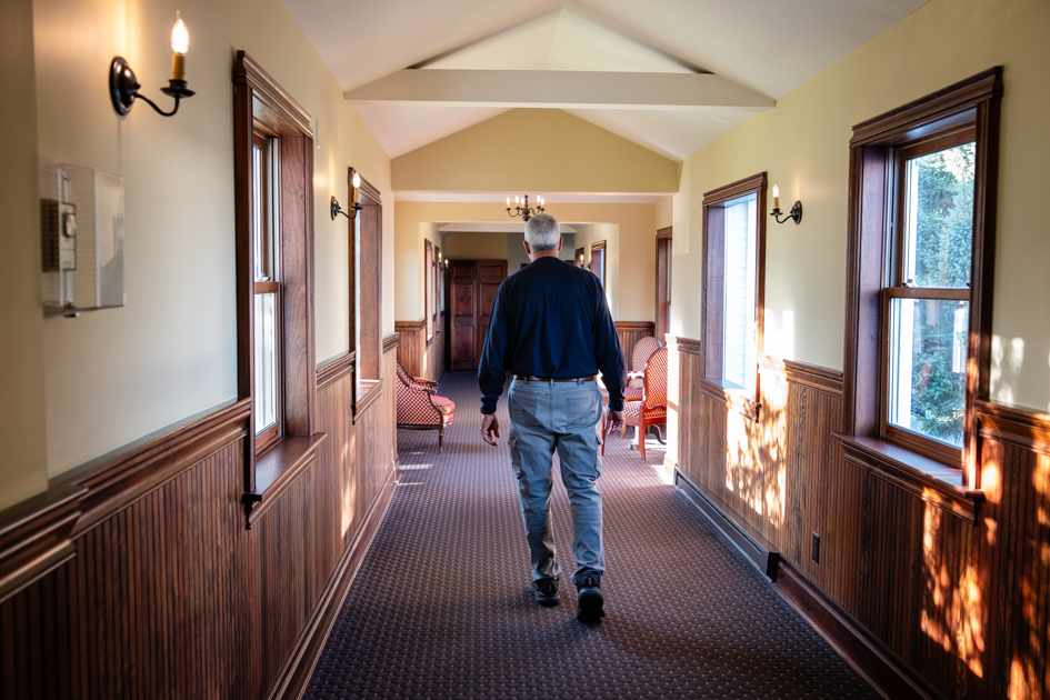 Walkway at Mirror Lake Inn in Lake Placid, New York, surrounded by greenery.
