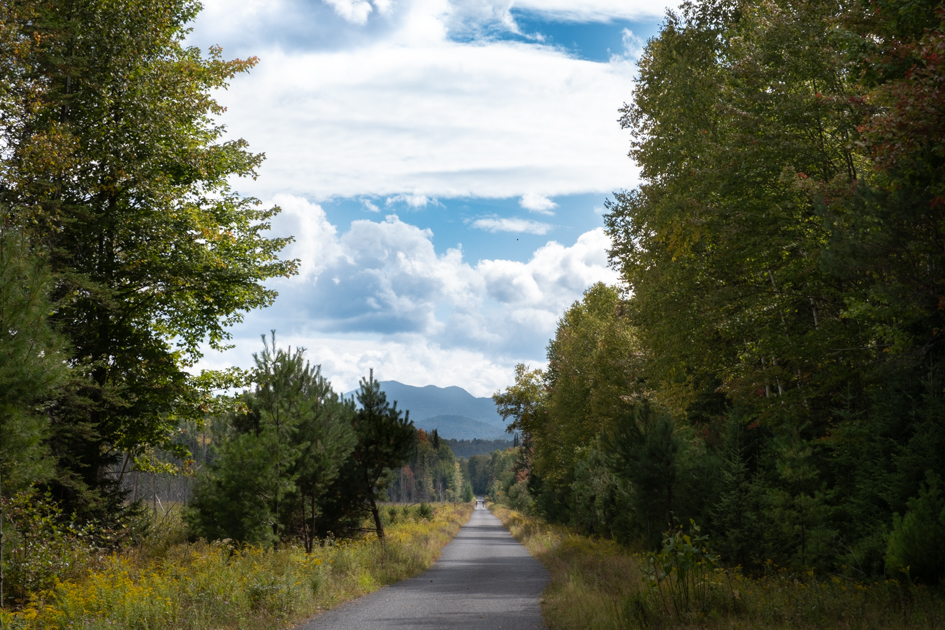 Bike trail in Lake Placid, New York, with Adirondack mountains in the background.
