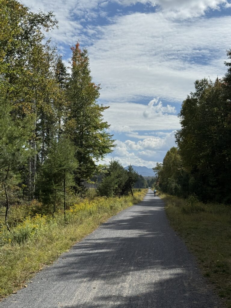 Lake Placid bike trail in New York with mountains in the background.
