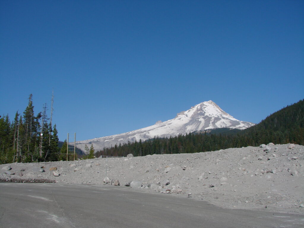 Mount Hood rising above evergreen forests under a clear sky