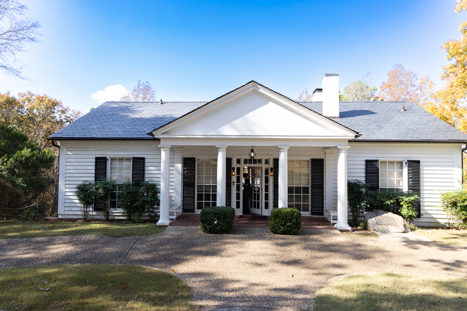 The Little White House in Warm Springs, Georgia, surrounded by trees and sunlight on a quiet afternoon.