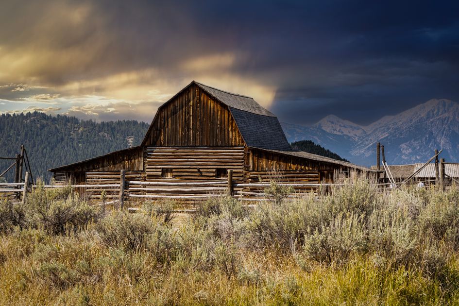 John Moulton Barn framed by golden morning light with the Teton Range in the background, Mormon Row, Grand Teton National Park
