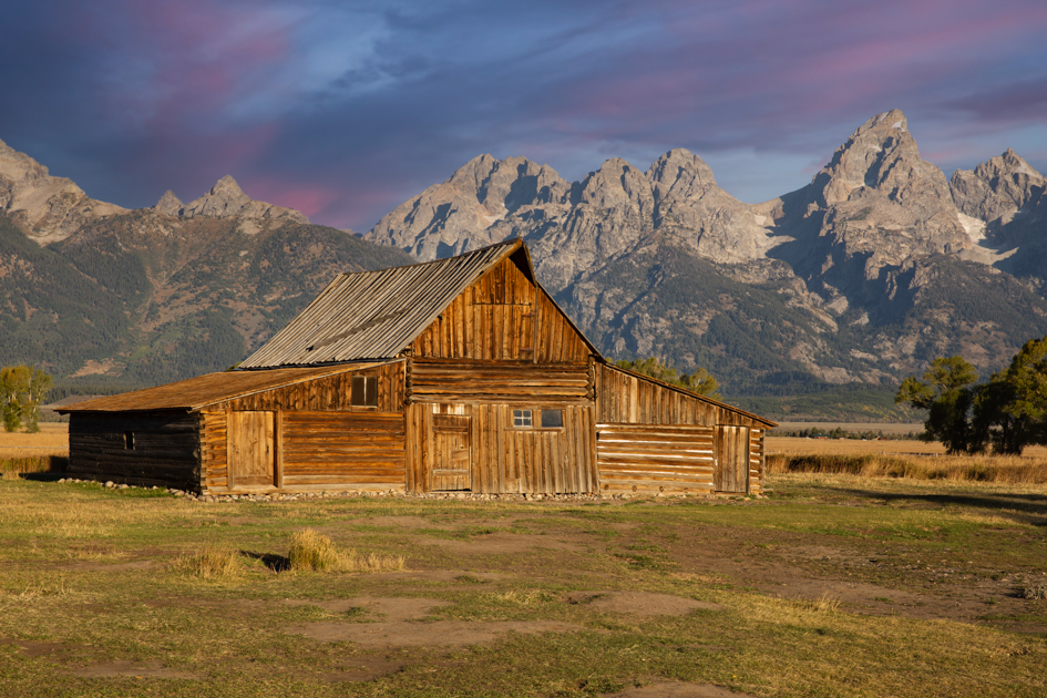 Dark storm clouds gather above the rustic T.A. Moulton Barn on Mormon Row in Grand Teton National Park
