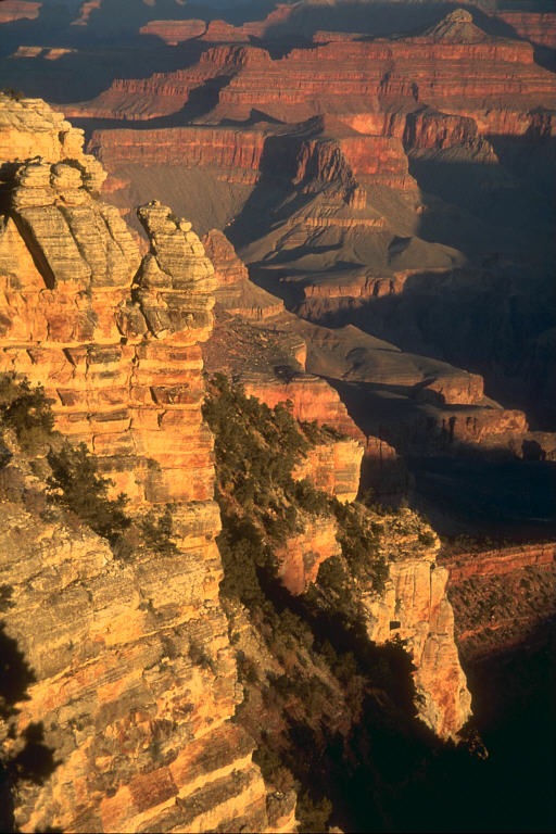 Grand Canyon landscape with layered red and orange cliffs under a bright blue sky