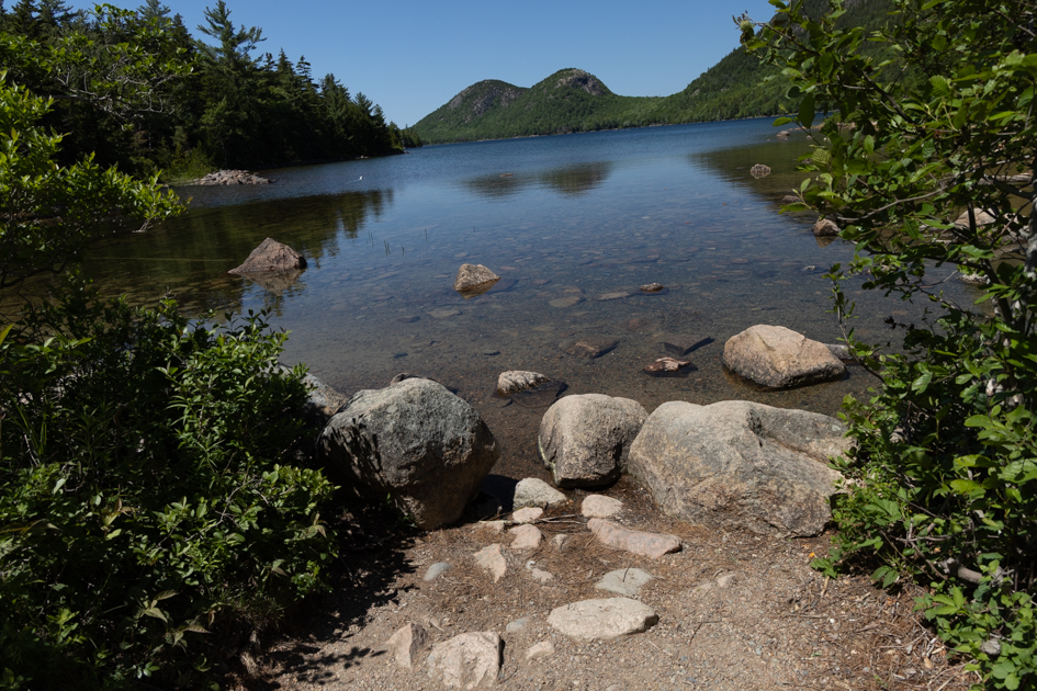 Still afternoon reflection of Jordan Pond and the Bubble Mountains in Acadia National Park, Maine.

