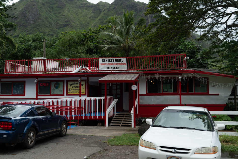 Front of Keneke’s Grill in Waimānalo, Oahu with sign advertising two quarter pound cheeseburgers for $5