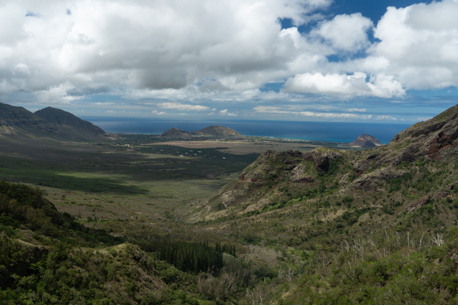 Narrow ridge section of Kolekole Pass Trail with cliffs on either side