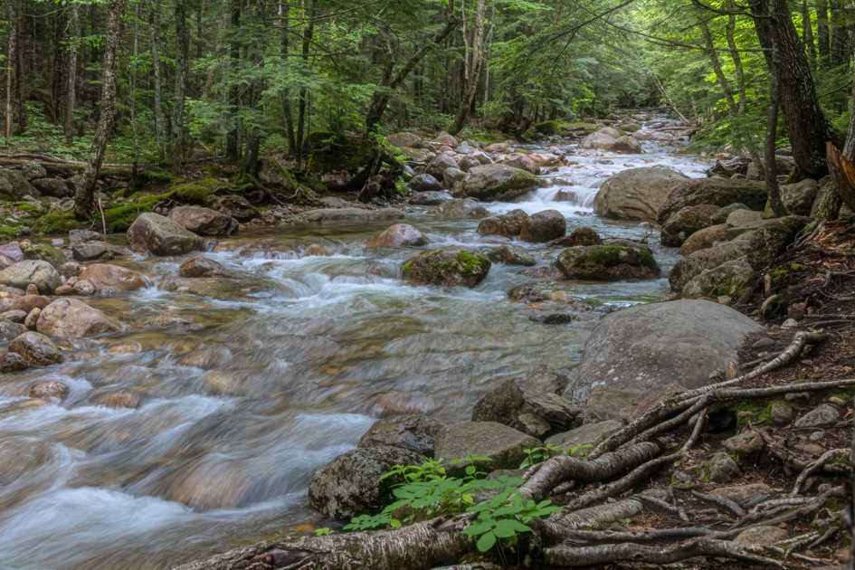 Smooth granite rocks in the clear Swift River near the Albany Covered Bridge along the Kancamagus Highway in New Hampshire’s White Mountains.
