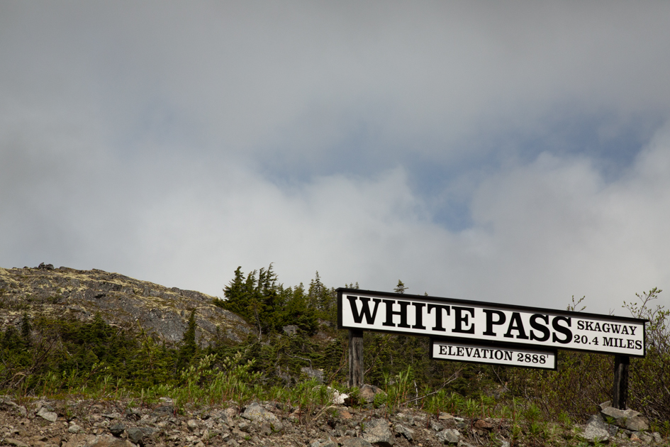 White Pass Summit sign marking the border between Alaska and Canada along the White Pass & Yukon Route Railroad

