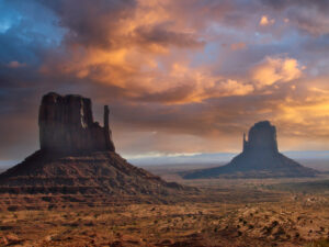 Sunset over Monument Valley transforms The Mittens into glowing silhouettes — a timeless symbol of the American Southwest. regional back roads and byways