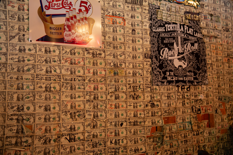 Inside Tortilla Flat Saloon with walls covered in signed dollar bills.