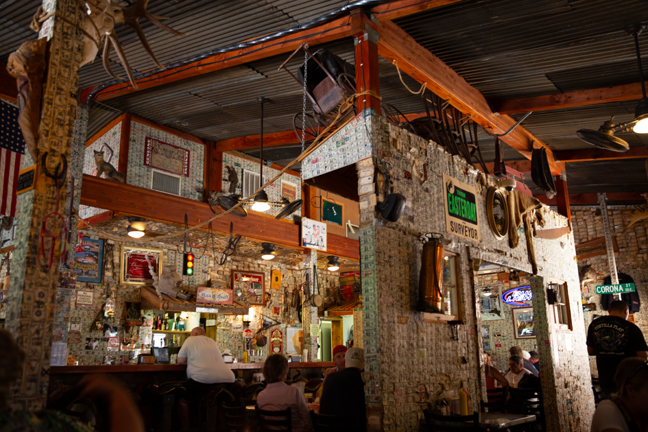 Inside the Tortilla Flat Saloon with walls covered in dollar bills and rustic Western décor.