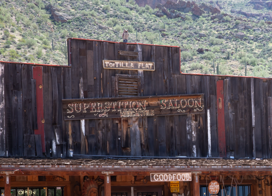 Exterior of the Tortilla Flat Saloon with rustic wooden façade and American flags along the Apache Trail in Arizona.