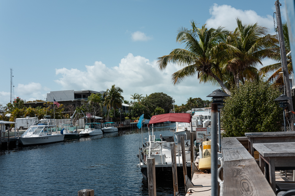Waterfront view at Shipwreck Bar and Grill in Key Largo with boats and calm marina water