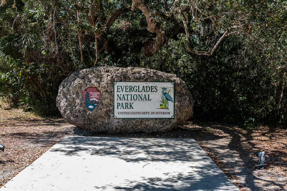 Everglades National Park entrance sign surrounded by tropical greenery in Florida