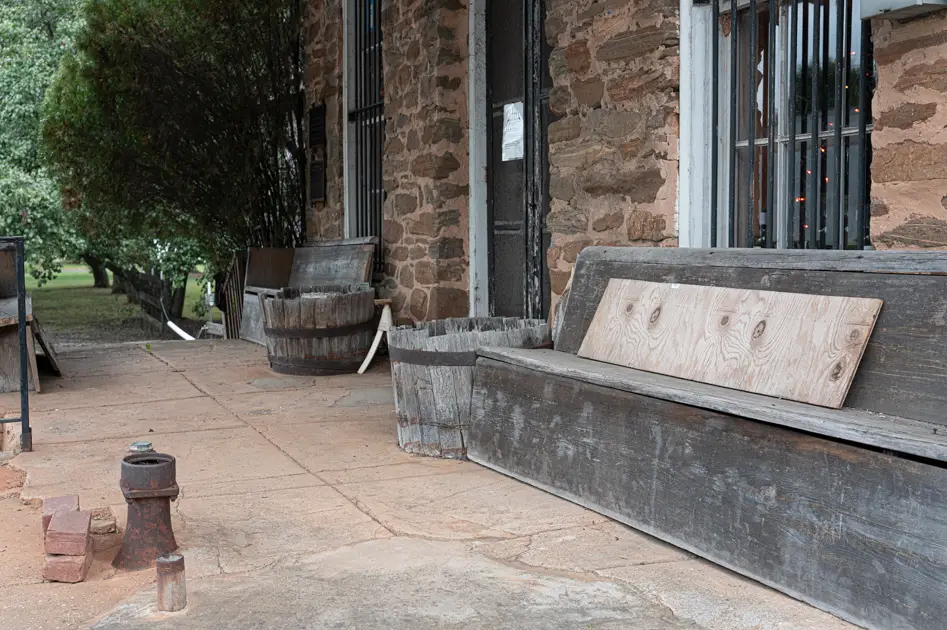 The weathered wooden porch of the historic Crossroads Store in Troup County, Georgia.
